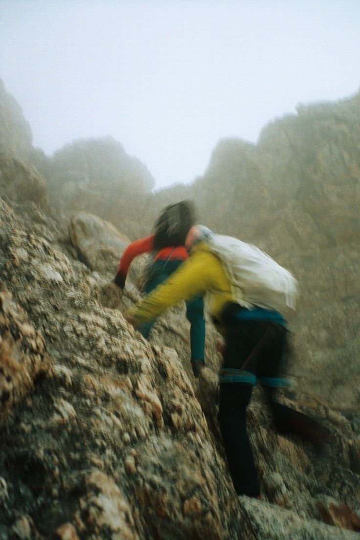 Dos senderistas avanzando por una montaña entre la niebla